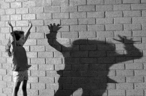 37196382 - little girl play with her shadow on brick wall. (bw)